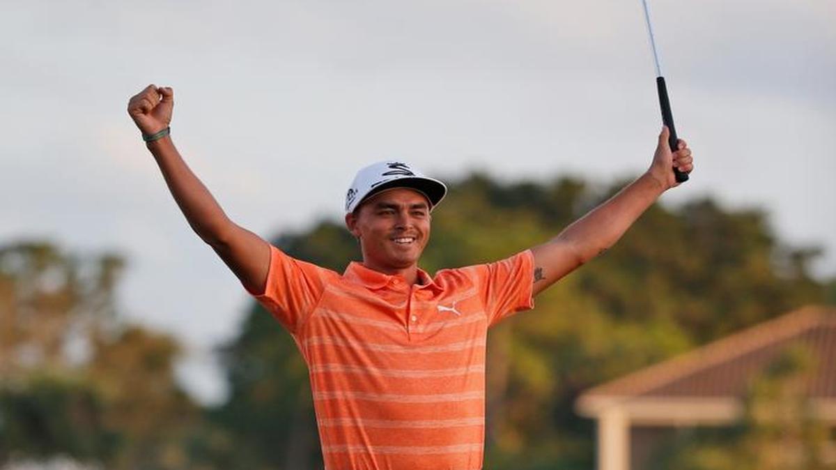 Rickie Fowler celebrates on the 18th green after winning the Honda Classic by four shots.