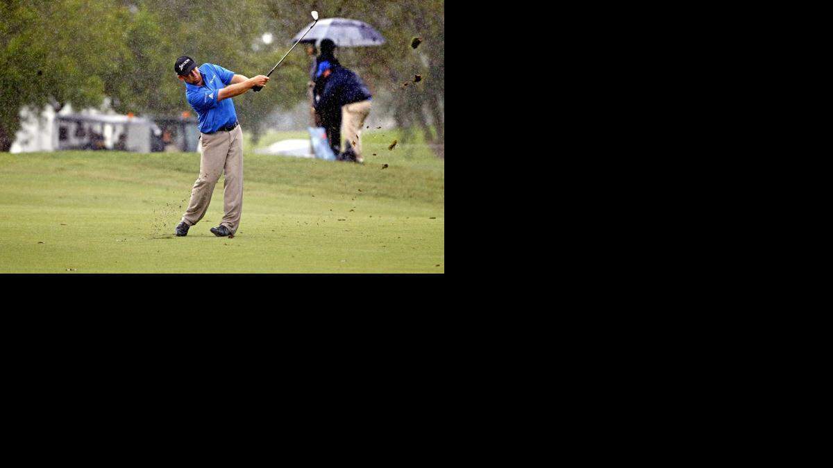 
Leader J. B. Holmes hits the ball in the 17th fairway while it rains in the third round of the World Golf Classic-Cadillac Championships at Trump National Doral, in Doral on March 7, 2015.
