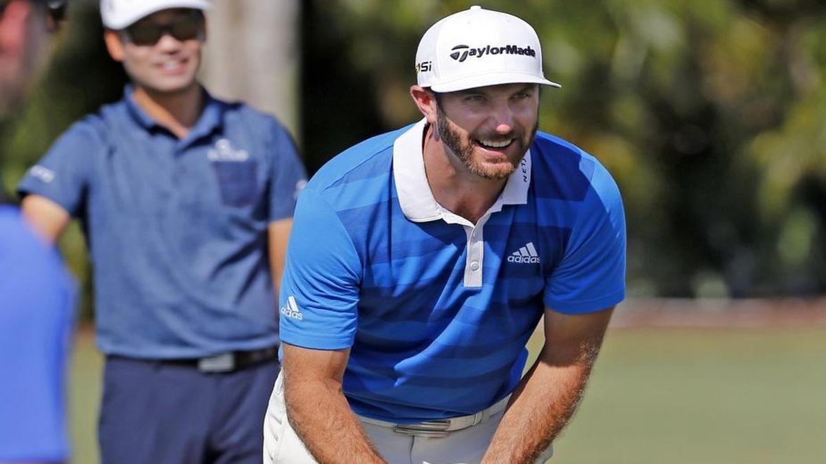 Defending champion Dustin Johnson talks to fellow players as he warms up on the driving range as he prepares for the WGC Cadillac Championship at Trump National Doral, in Miami, Florida, March 2, 2016.