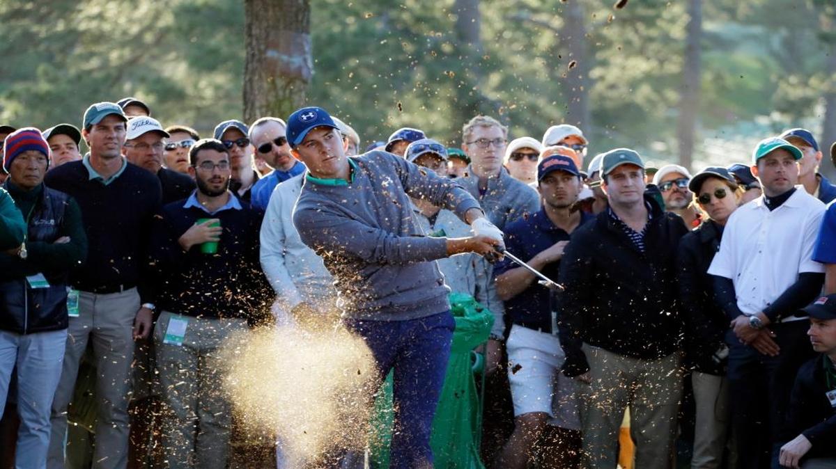 After an errant drive right, Jordan Spieth hits out of the pine straw in the trees on No. 17 that led to a bogey. Spieth hit another errant drive on No. 18 that led to a double bogey.