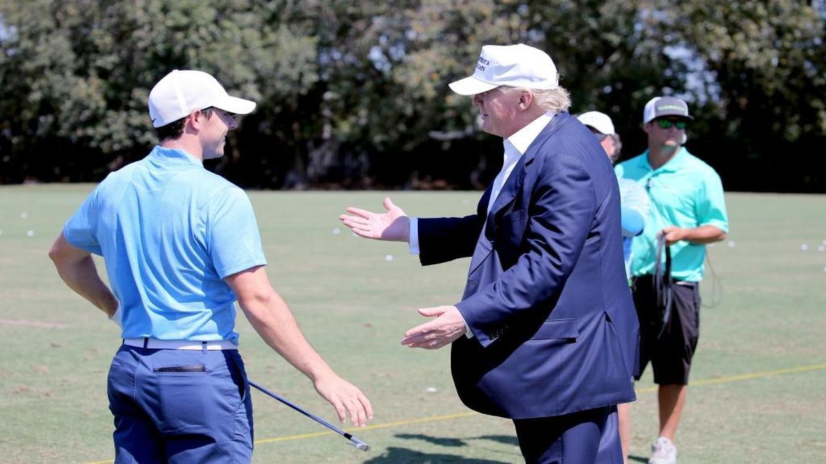 Republican Presidential candidate Donald Trump talks with golfer Rory McIlroy on the driving range as he prepares for the final round of the WGC-Cadillac Championship at Trump National Doral in Miami, Florida, on Sunday, March 6, 2016.