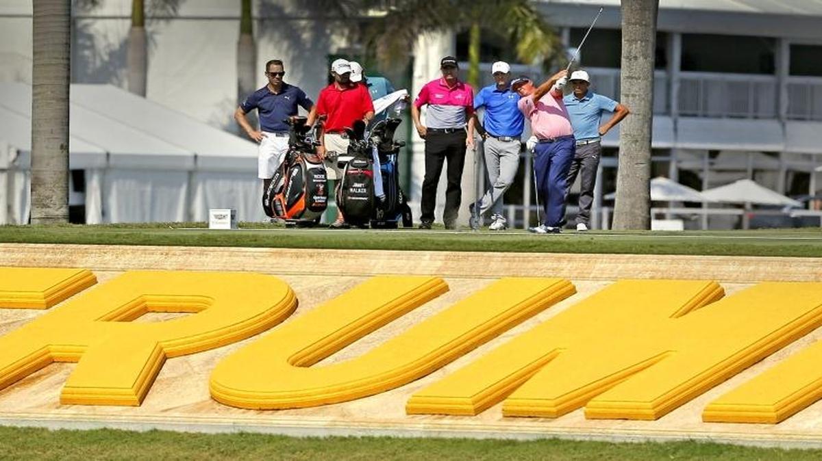 Jimmy Walker, Jordan Spieth and Rickie Fowler watch as Jason Dufner tees off on the 9th hole as they play a practice round before the 2016 WGC-Cadillac Championship at Trump National Doral in Miami, Florida, March 2, 2016.