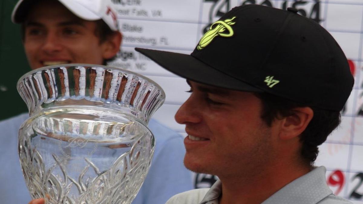 Jorge Garcia holds the trophy after winning the South Beach International Amateur golf tournament on Dec. 23, 2015.