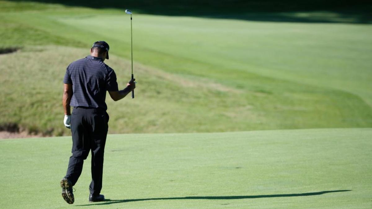 FILE - In this Aug. 12 2015, file photo, Tiger Woods reacts after his approach shot on the 18th hole during a practice round for the PGA Championship golf tournament at Whistling Straits in Haven, Wisc. Woods pulled out of his next two tournaments because of ongoing back problems, a somber outlook for a 14-time major champion whose comeback barely lasted three tournaments before another setback. Woods said Friday, Feb. 10, 2017, on his website that he was still coping with back spasms that he attributed to his withdrawal from the Dubai Desert Classic last week.