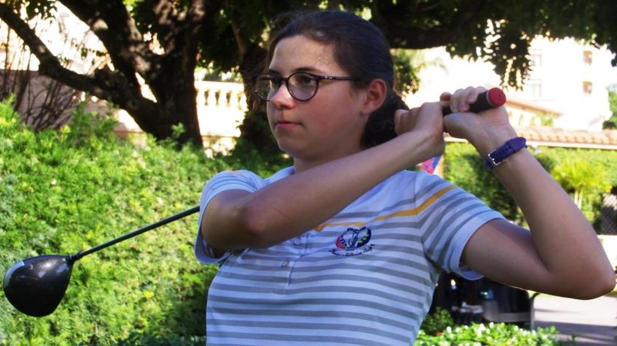 Agatha Laisne practices her swing at Biltmore Golf Course.