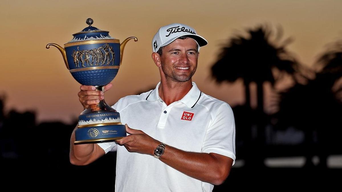Adam Scott holds up his trophy after winning the final round of the 2016 WGC-Cadillac Championship at the Trump National Doral on Sunday, March 6, 2016.