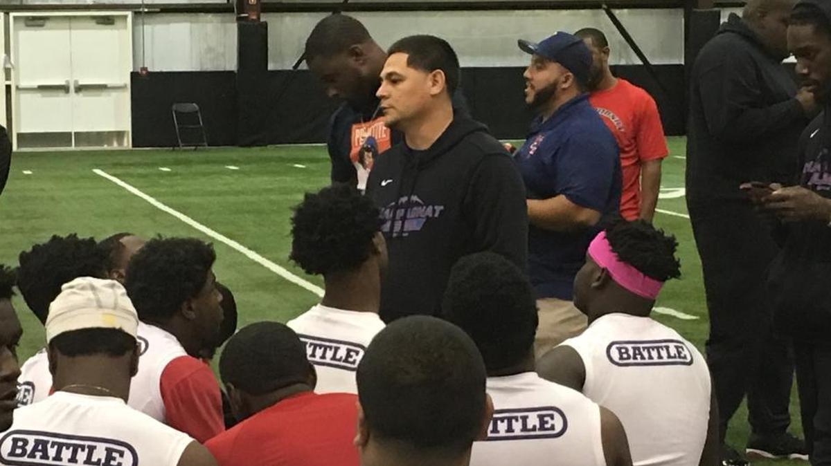 Champagnat football coach Dennis Marroquin talks to his players after practice on Thursday afternoon at the University of Central Florida’s indoor facility. The Lions play for the Class 2A state football championship on Friday morning in Orlando.