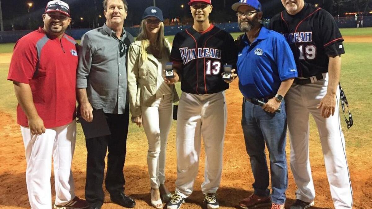 Washington Nationals pitcher Gio Gonzalez, who helped the Hialeah High School Thoroughbreds win two Class 6A state championships (2001 and 2002), received two state championship rings from the school and Fox-Mar. Gio has continually donated to the school and the baseball program; so the school surprised him with the rings because his original state championship rings were stolen. Pictured with Gonzalez are Hialeah High basbeall coach Juan Garcia, the Fox-Mar president and his wife, Hialeah High Principal Heriberto Sanchez and former Hialeah High baseball coach Rich Bielski.