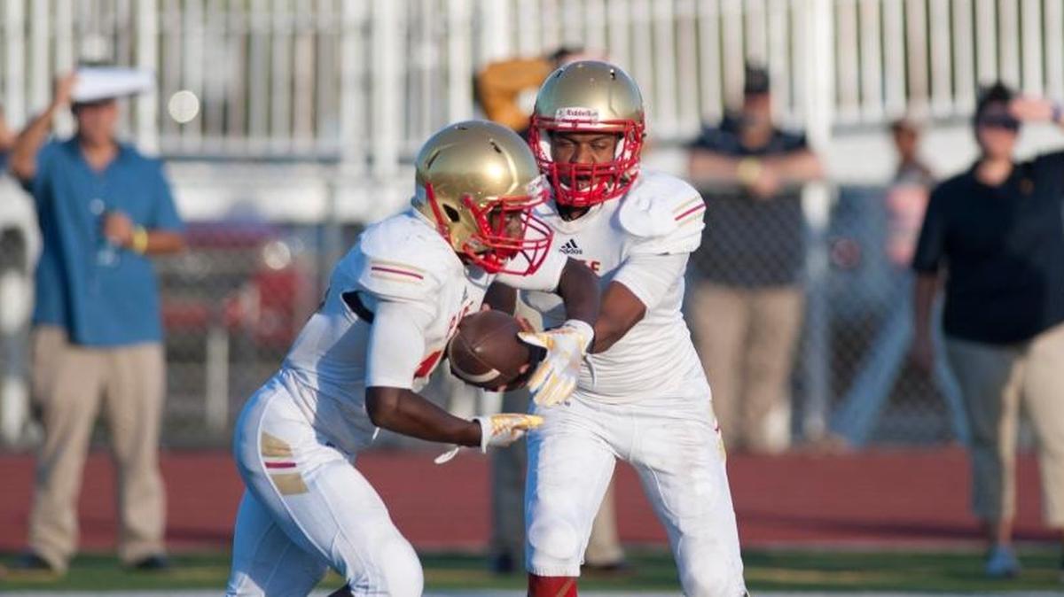 Lorenzo Floyd from Monseignor Pace hand the ball off to Ki' Sean Bullard during third quater action n a high school football game Friday November 2, 2017 in Miami against Belen Jesuit.