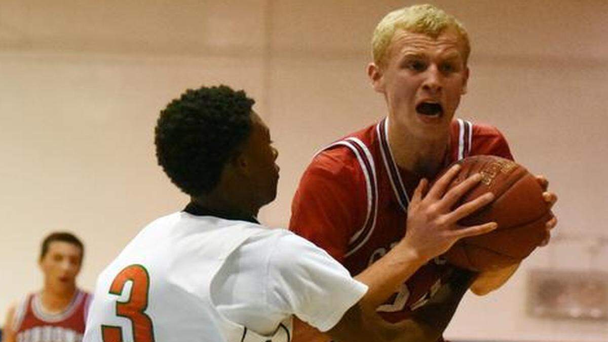 
Maverick Rowan of Cardinal Gibbons (right) battles for possession with Geremy Taylor of Ely High.
