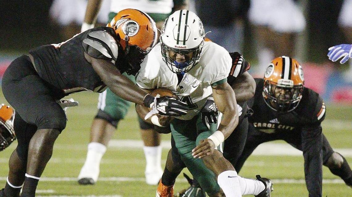 Miami Central Rockets' running back James Cook carries the ball against the Carol City Chiefs during the football game on Friday, Oct. 27, 2017, at Traz Powell Stadium in Miami.