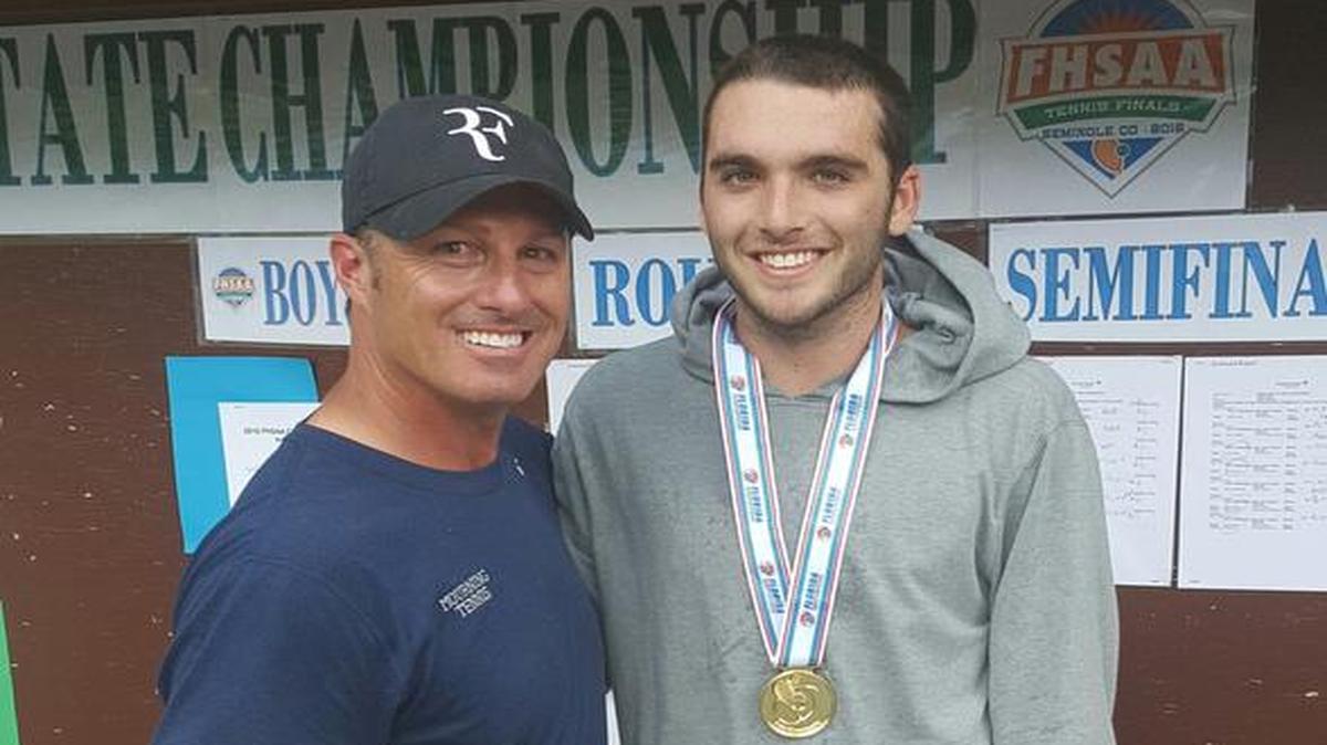 Mourning’s Tom Jaworski, right, poses with coach Todd Rubinstein after winning the 3A singles title.