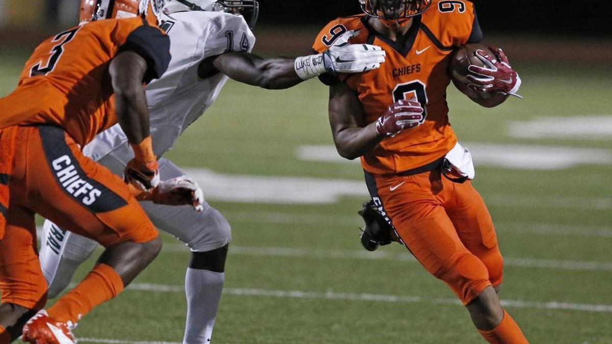Carol City receiver Victor Tucker gains yardage against Central at Traz Powell Stadium on Saturday, Oct. 3, 2015.
