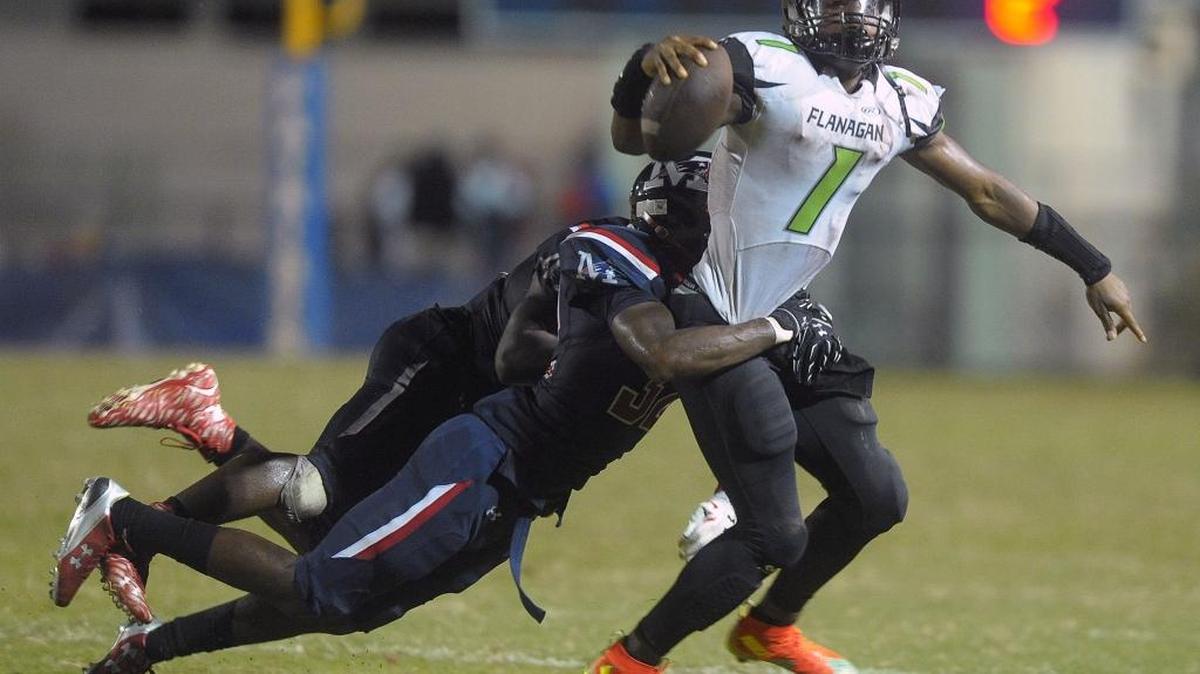 Flanagan quarterback Kalyn Nelson drags Miramar’s Tavares Ladler before being tackled Friday, October 2, 2015 at Miramar High School.