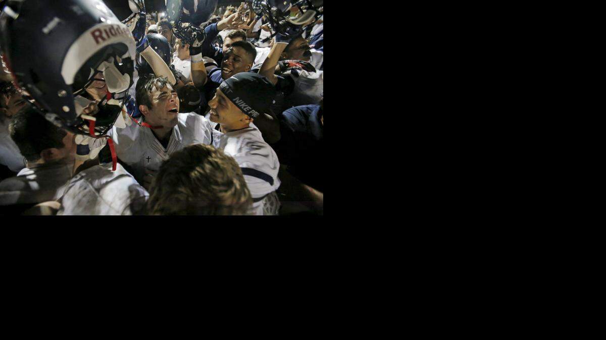 
Columbus’ Juan Carlos De Los Santos, center, celebrates with his team after beating Flanagan this past Friday to reach the 8A title game.
