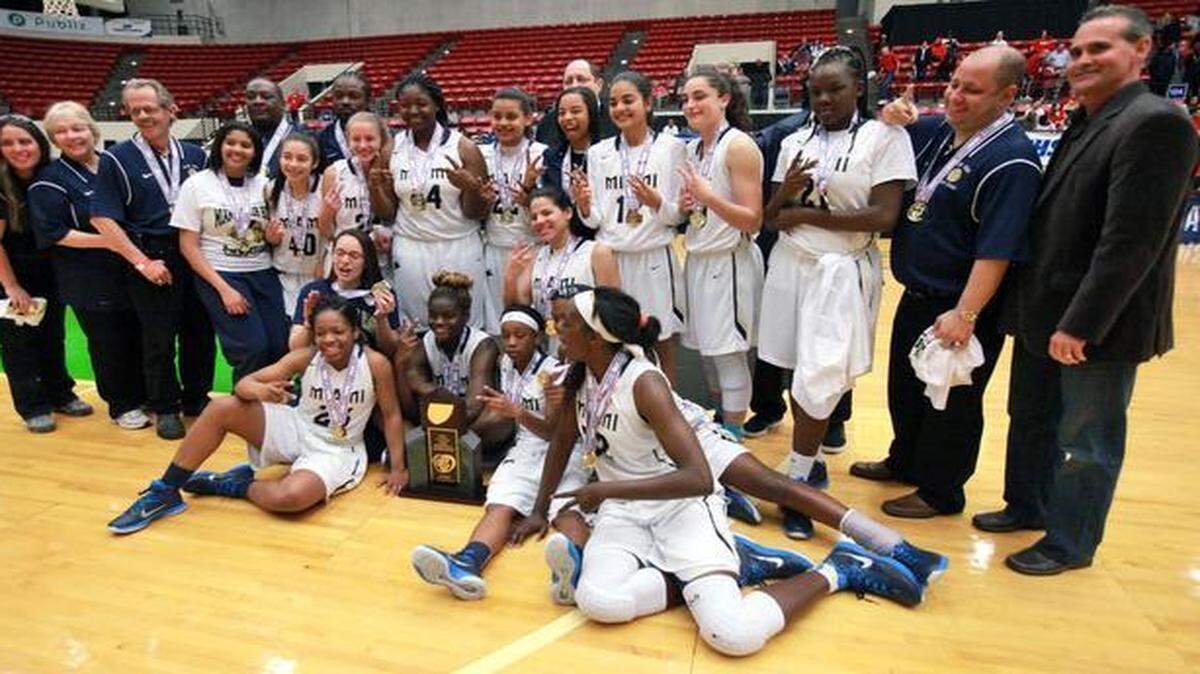 
Miami High team members pose for photos after winning the state title against Orlando Colonial during the FHSAA Girls 8A Basketball championship at The Lakeland Center in Lakeland on Feb. 21, 2015.
