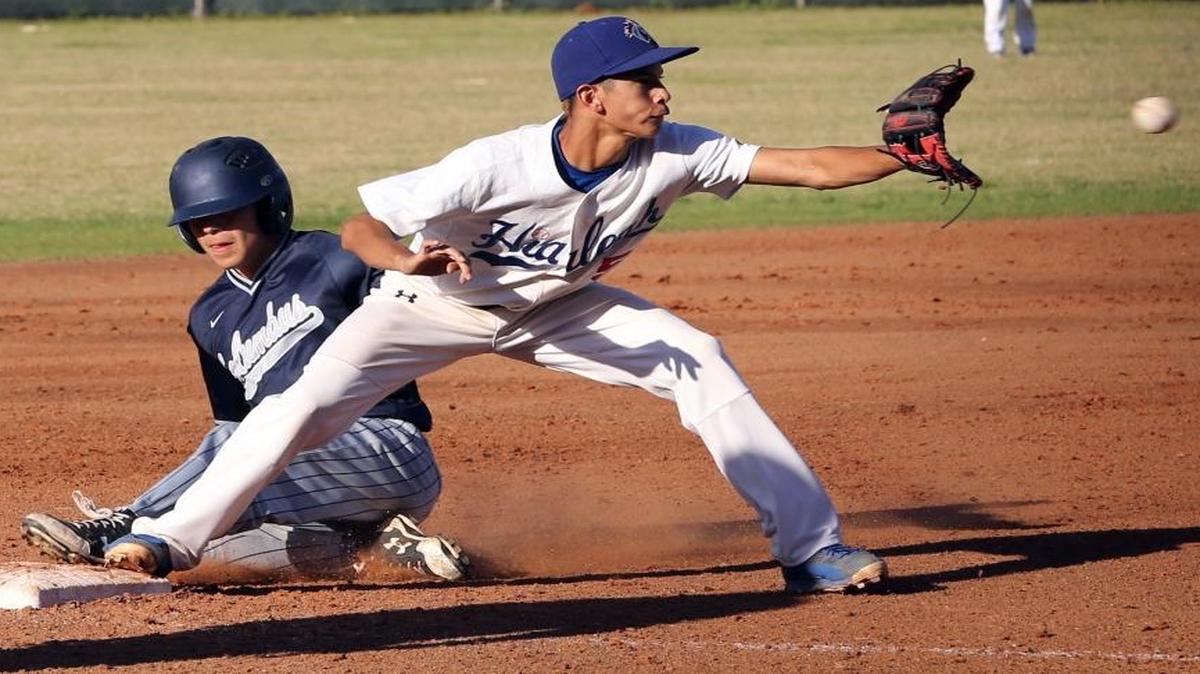 Columbus HS Joel Gonzalez, 18, slides safely into second base as Hialeah HS Lazaro Mendoza, 5, waits for the ball in the semifinals at Killian HS, April 25, 2017.