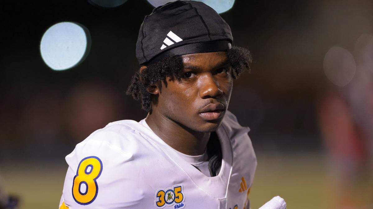 Northwestern Bulls quarterback Neiman Lawrence (8) looks on from the bench before the second half of a high school football game against the Columbus Explorers at Tropical Park in Miami, Florida, Friday, September 19, 2025.