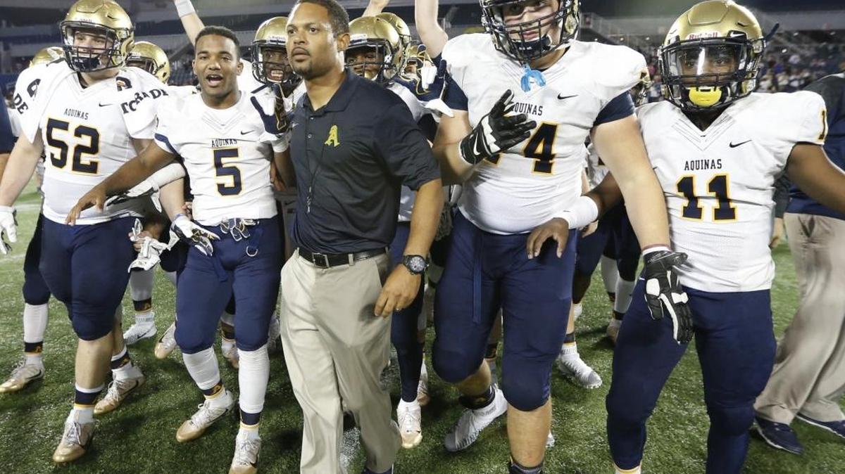 St. Thomas Aquinas Head Coach Roger Harriott leads the team onto the field after defeating Viera 45-10. St. Thomas Aquinas vs Viera Hawks at the 2015 FHSAA Football Class 7A Championship at the Citrus Bowl in Orlando on Fri., Dec. 11, 2015