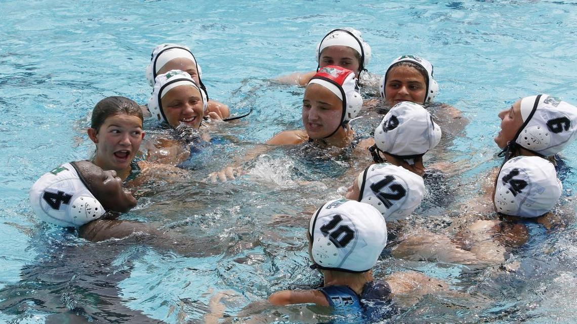 Ransom Everglades High Scholl girl's water polo team celebrates victory after winning the state championship game against Olympia on Saturday, April 16, 2016 at Ransom Everglades High School in Coconut Grove.