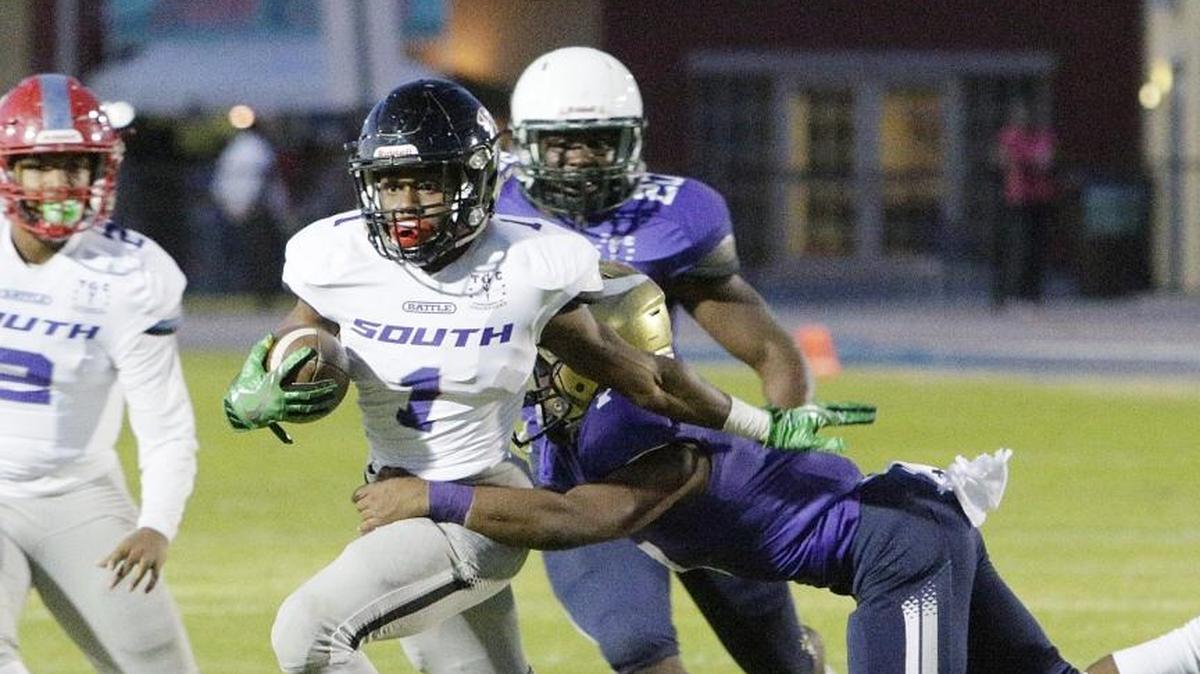 Miami-Dade South running back Darren Davis (1) attempts to escape a Miami-Dade North defender during the All-Star game on Saturday, December 16, 2017 at Ansin Sports Complex in Miramar.
