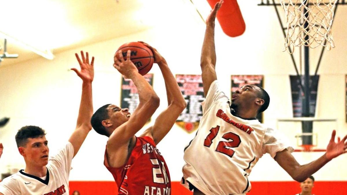 Westminster Academy Paul Atkinson 20, drives to the basket into Sagemont HS Tyler Polley 12, in the Class 4A, Region 3 playoffs at Sagemont HS on Tues., Feb. 21, 2017.