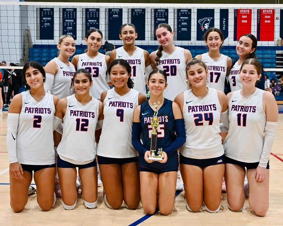 The Florida Christian School girls’ volleyball team pictured after winning a tournament it hosted in the school’s gym.