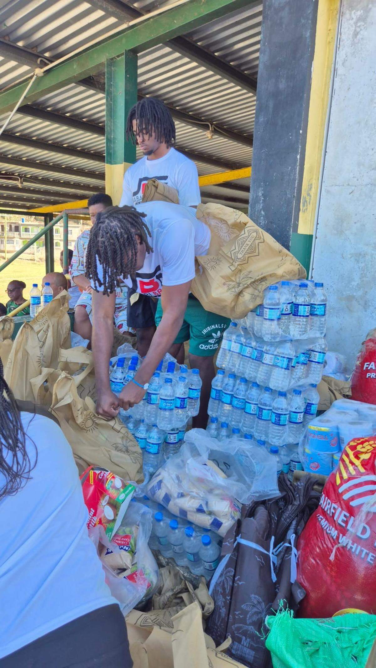 Jabari Brady of the Monarch High School football team helping with hurricane relief in Jamaica.