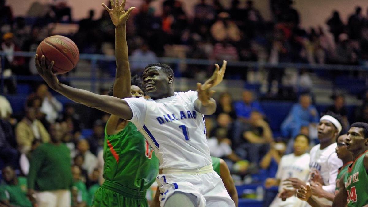Dillard's Jordan Wright scores in front of Ely's Joshua Scott during the first half of their Big 8 Boys Basketball Championship game, Saturday, January 30, 2016.