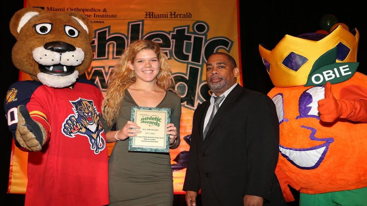 South Broward’s Mackenzie Sadaka, left, poses for a photo with the Miami Herald assitant sports editor John Devine after winning the 2015-2016 Leo Saurez/Walter Krietsch Courage Award.