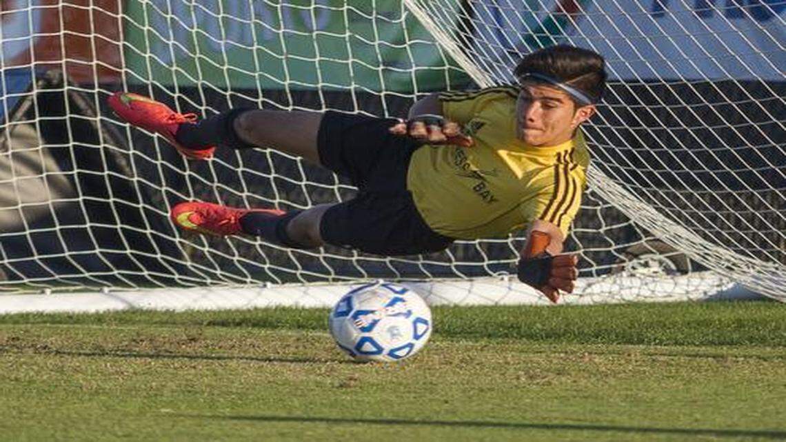 
Cypress Bay Lightning (in white) and West Orange Warriors (in blue) played for the championship game in the Class 5A at the FHSAA State Championship held at the campus of Eastern Florida State College in Melbourne, Florida. Cypress Bay goal keeper Juan Calle blocks a ball during the shoot out. Photo by Mike Brown
