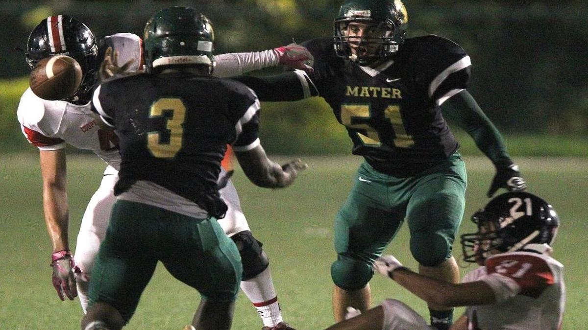 Mater Academy Daniel Doriscar loses the ball, left, as teammate Andy Gonzalez, 51, looks after Cooper City Justin Croye, right, caused the turnover but Mater kept the possession of the ball. On Thurs., Nov. 10, 2016 Mater Academy played against Cooper City in football playoff game at Milander Park in Hialeah.