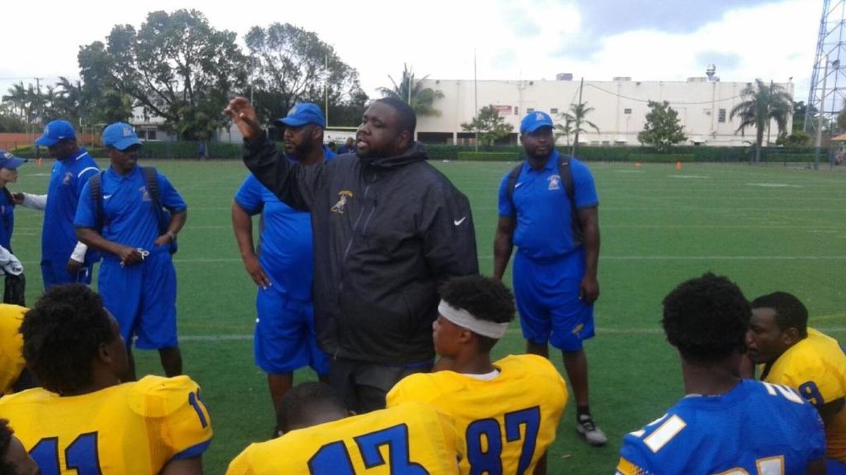Northwestern interim head coach Verne Louis talks to his players following the Bulls’ 47-0 win over Hialeah-Miami Lakes on Tuesday afternoon at Milander Park.