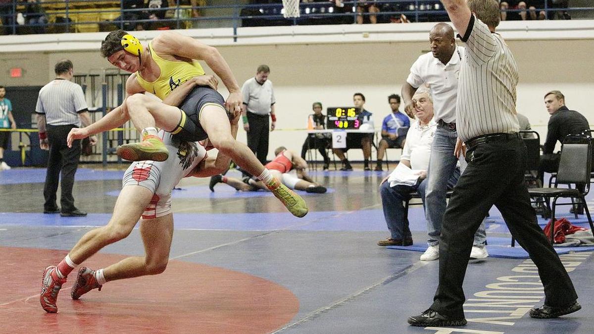 Cardinal Gibbons' Amadeus Conception attempts to take down St. Thomas Aquinas' Grant Aranoff during the BCAA wrestling Championships 145-pound class final match on Jan. 21, 2017 at Pompano Beach High School.