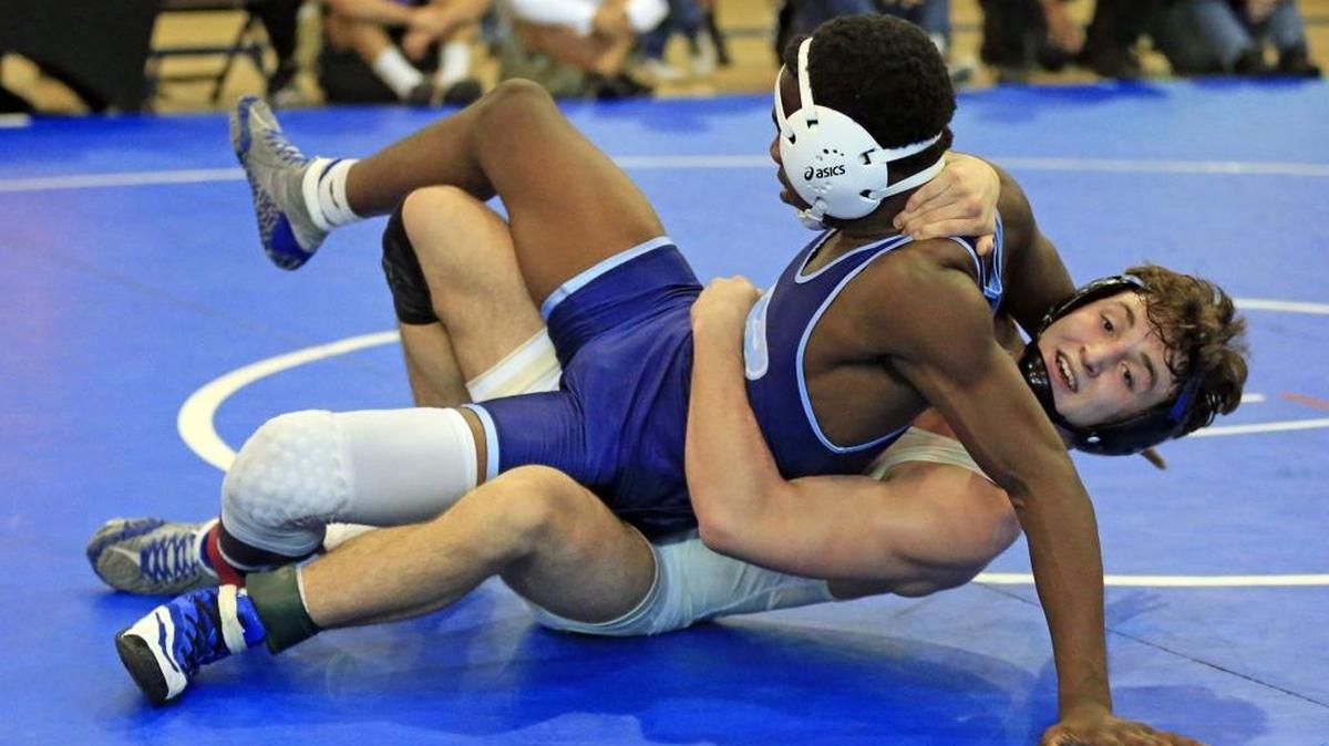 Brevin Balmeceda, at bottom, battles Cardeionte Wilson of Miami Palmetto high School. Balmeceda goes on to defeat Wilson during GMAC wrestling finals at Ronald W. Reagan Doral Senior High School on Saturday, February 3, 2018.