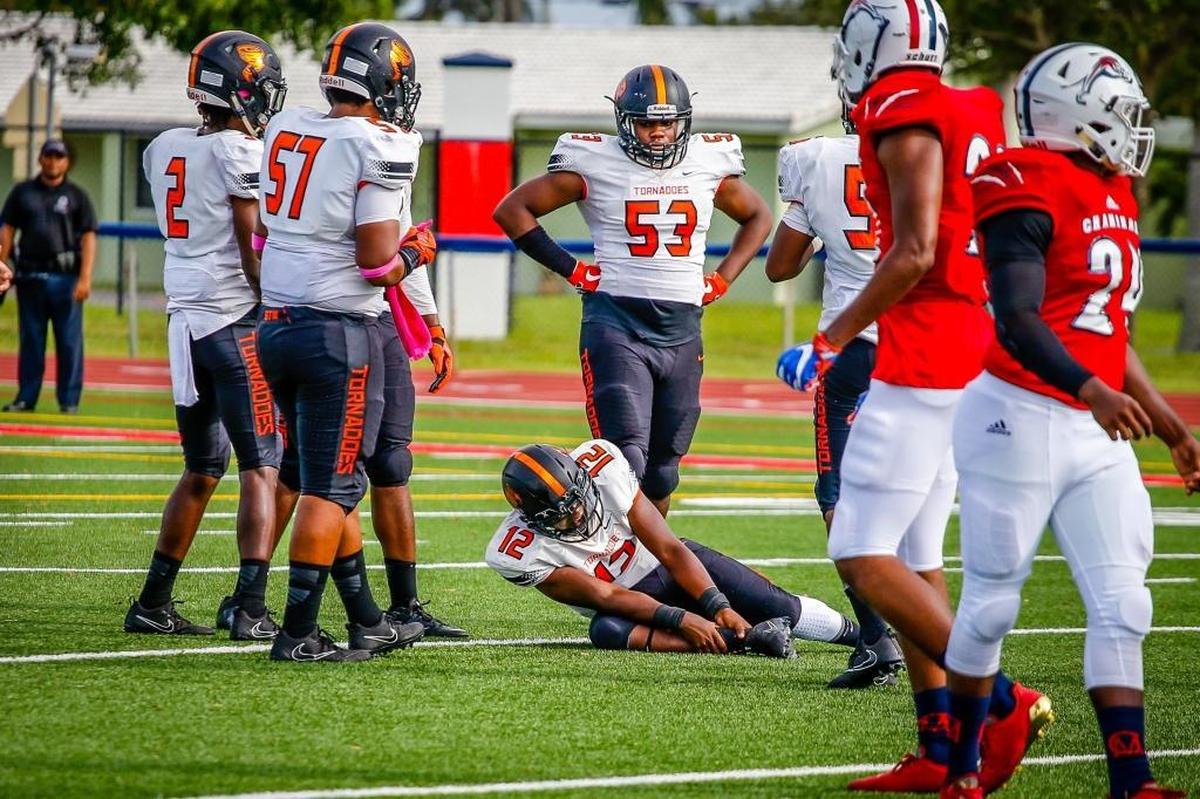 Booker T. Washington player Daniel Richardson is injured, before being removed from the field, during a game between Booker T. Washington and Chaminade-Madonna College Preparatory School at Chaminade-Madonna College Preparatory School in Hollywood, Fla.