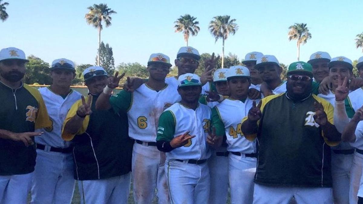 Killian baseball coach Angel Herrera (far right) celebrates with his players Wednesday after he won his 200th career game.