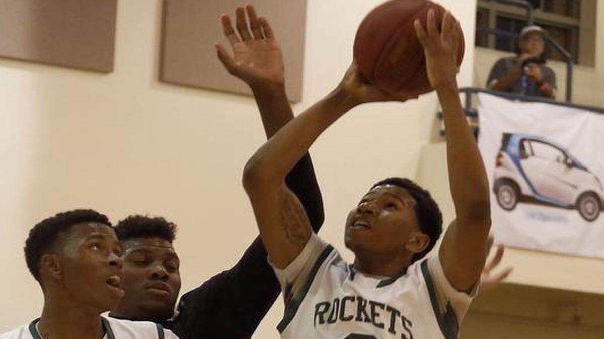 
Miami Central player Phillip Saunders, center, drives towards the basket during the GMAC final against Miami Beach on Thursday, Jan. 29, 2015 at Miami High. 

