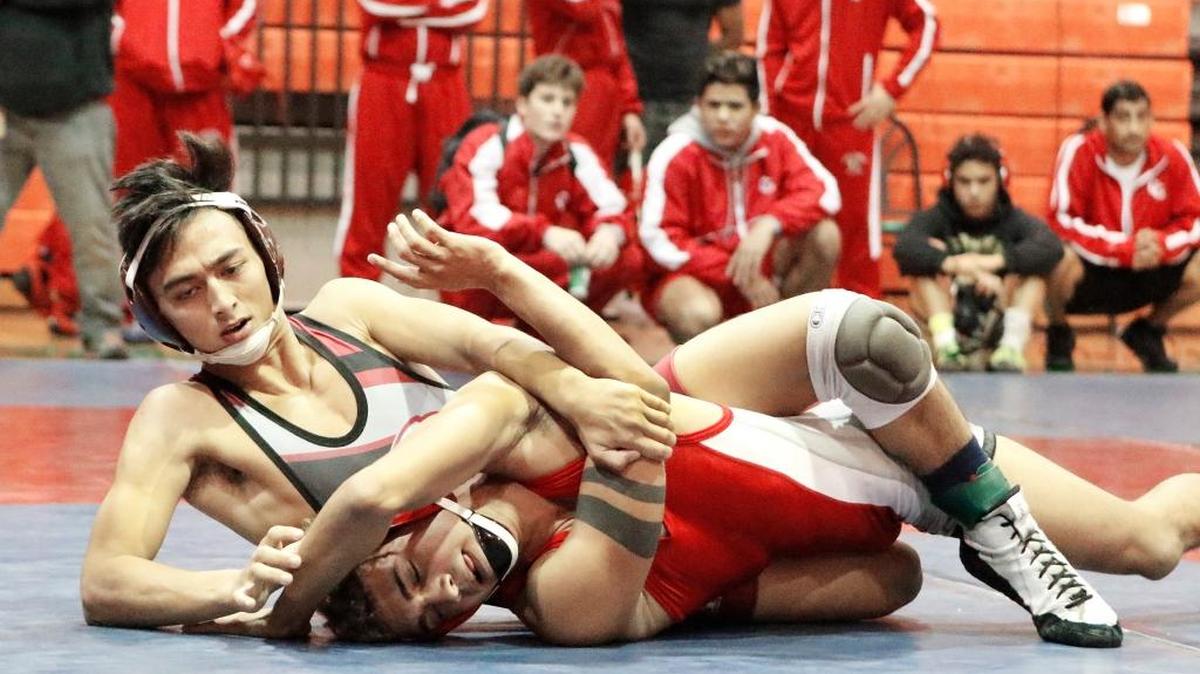Douglas' Steven Erched (on top) wrestles Cardinal Gibbons' Gabriel Gibson during 126-pounds the BCAA wrestling championship final match on Saturday, Jan., 27, 2018, at Blanche Ely High School in Pompano Beach.