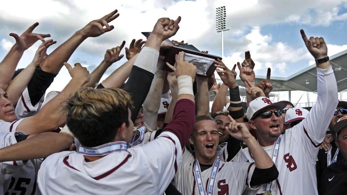 Coach Todd Fitz-Gerald, right, celebrates with his players Saturday they delivered Douglas’ first state championship.
