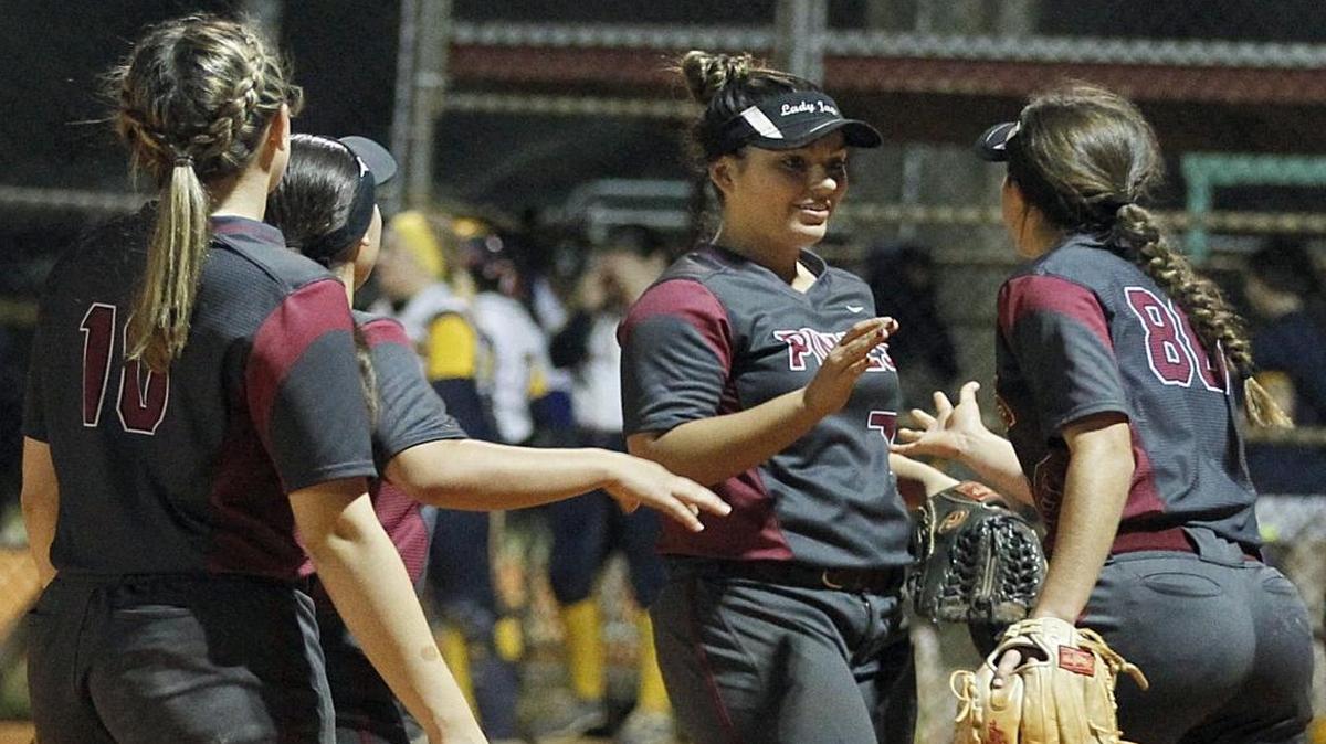 Pines Charter softball teammates greet pitcher Aliza Gonzalez after defeating St. Thomas Aquinas High School 2-0 to win the BCAA Big 8 softball championship at Silver Lakes Park South on Fri., April 21, 2017.