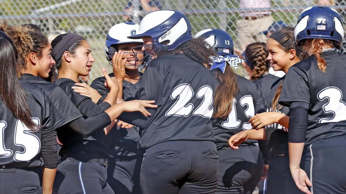 Gulliver Prep’s CiCi Castillo (22), is met at home plate by teammates after hitting a home run in the fourth inning — one of her two homers in the game — during Tuesday’s victory over Monsignor Pace.