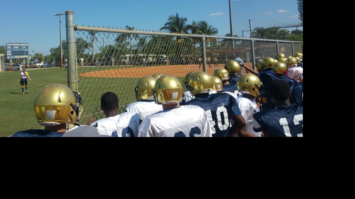 
The St. Thomas Aquinas football team takes a break from spring practice to take in the Raiders' softball regional final against West Boca on Friday afternoon. 
