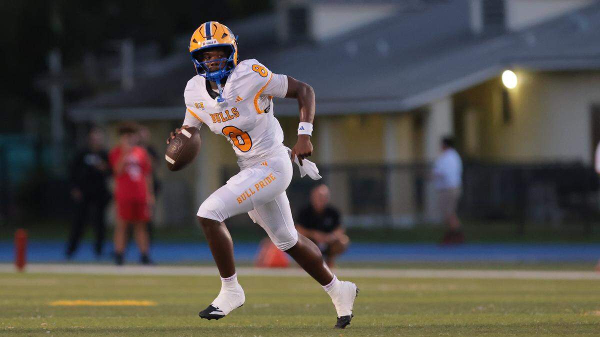 Northwestern Bulls quarterback Neiman Lawrence (8) carries the football against the Columbus Explorers during the first quarter of a high school football game at Tropical Park in Miami, Florida, Friday, September 19, 2025.
