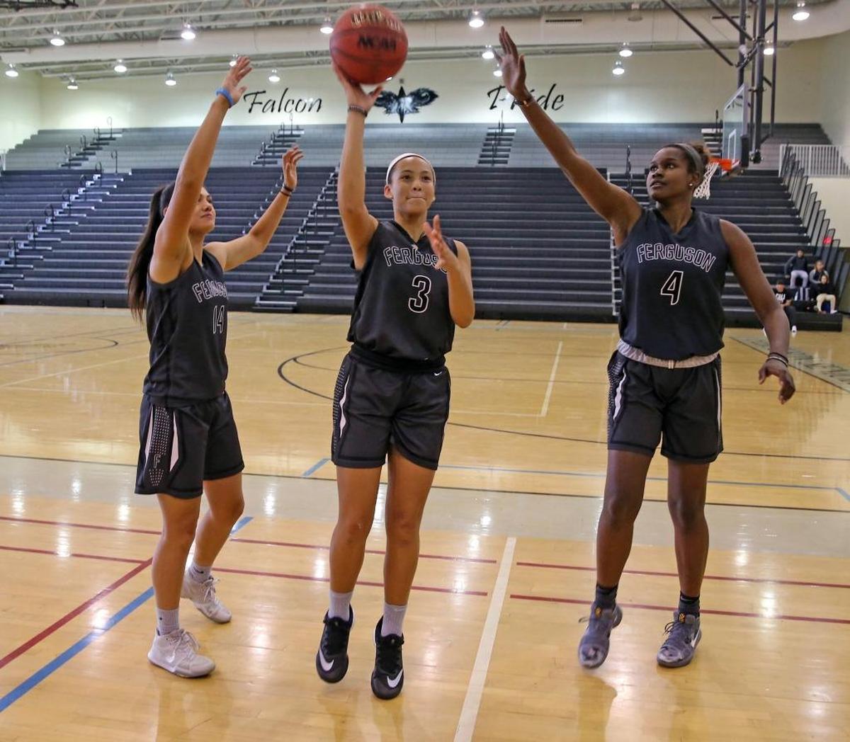 Ferguson HS girl's basketball team members Natalia Pineda 17, committed to Eastern Michigan, Sheslanie Laureano 17, committed to FIU, and Cheyanne Daniels 17, committed to FIU, in the gym at Ferguson HS, Nov. 29, 2017.
