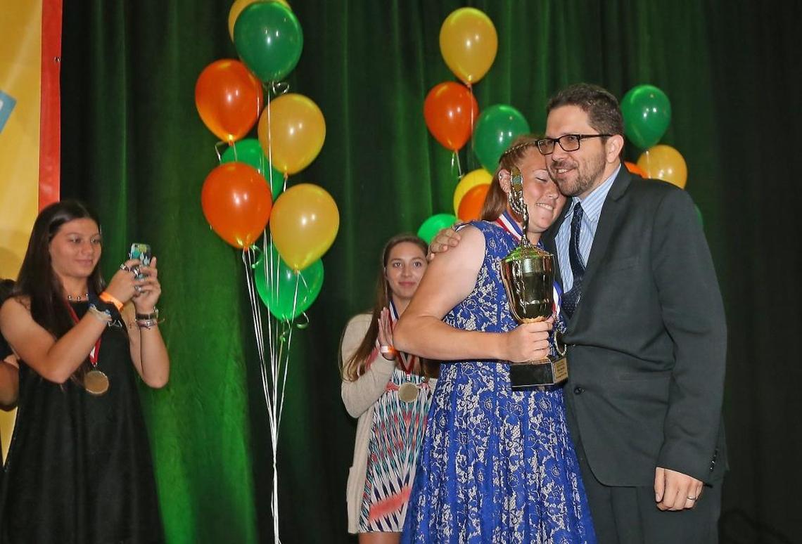 Class 5A-1A Female Athlete of the Year Coral Springs Charter's Allison Muraskin gets a hug from Herald Sportswriter Andre Fernandez as she receives her softball award at the Miami Herald Broward Athletic Awards banquet at the Signature Grand in Davie on Thurs., May 25, 2017.