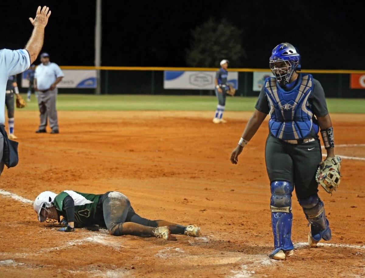 Westminster Christian Ashley Castano, 4, lays on the field after she injured her leg sliding into home plate as they play Trinity Christian at the FHSAA Semifinals in Vero Beach, FL, May 17, 2017.