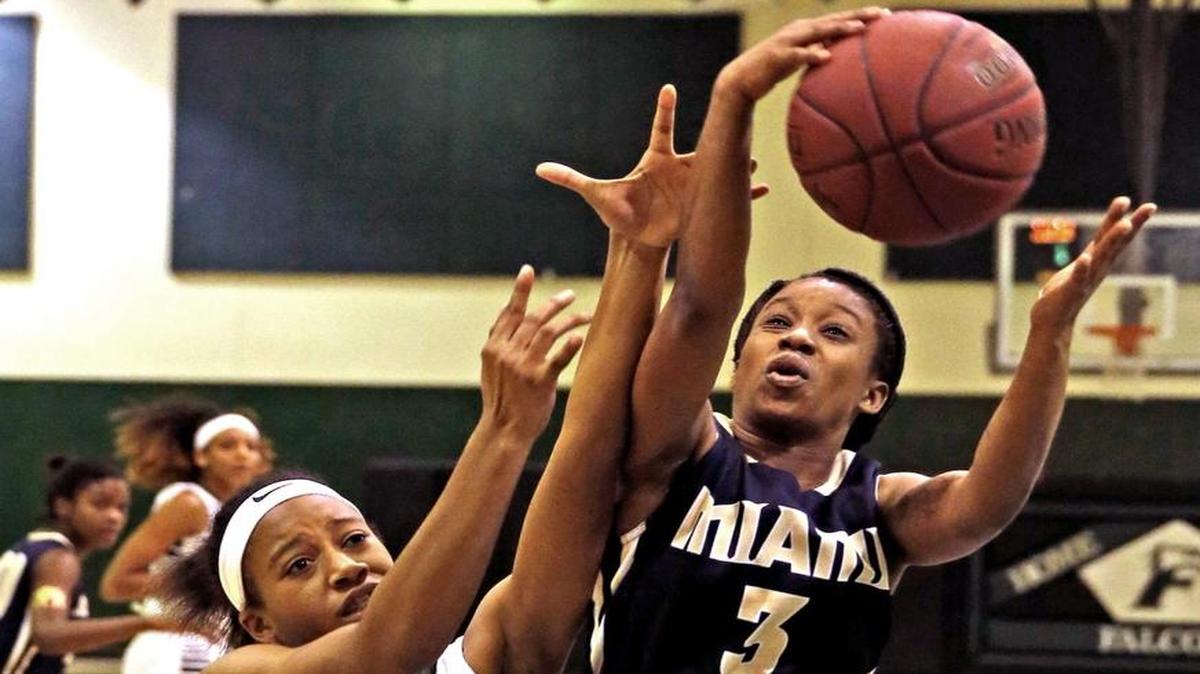 Miami High’s Andrisia Sweeting, right, battles for possession with Flanagan’s Jayda Theodule during the Region 4-8A girls’ basketball semifinal at Flanagan High in Pembroke Pines, February 9, 2016.