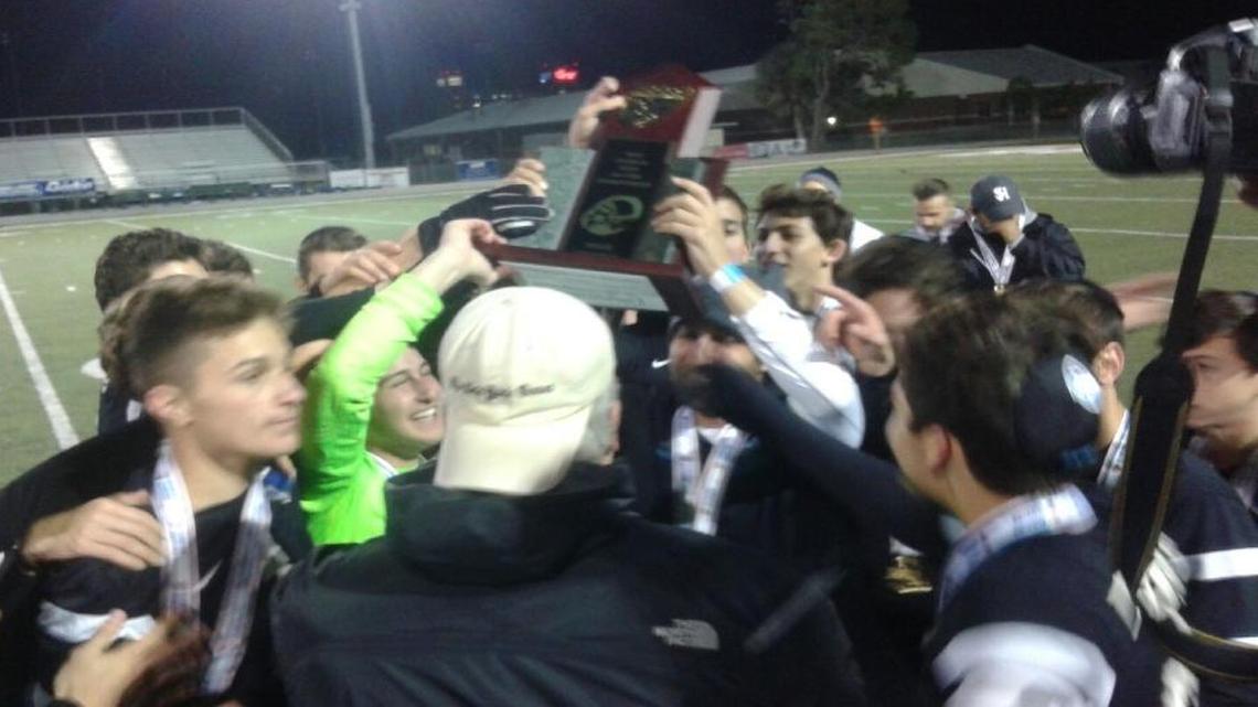 Hillel players show off the Class 1A boys’ state title trophy after a dramatic overtime victory against Maitland Orangewood Christian on Tuesday, Feb. 9, 2016 at Melbourne High School.