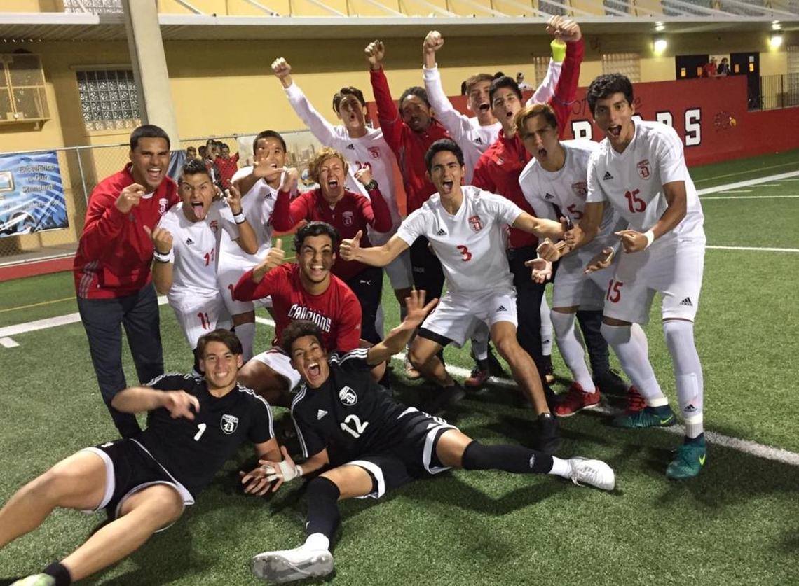 Pamela McDonald stands with her Doral Academy boys’ soccer team.